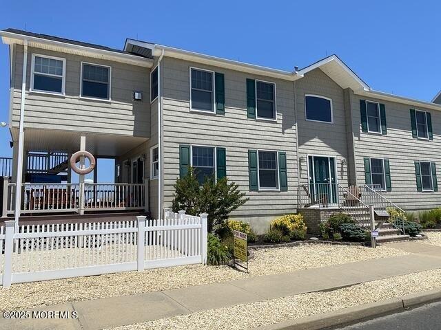 view of front of house with fence