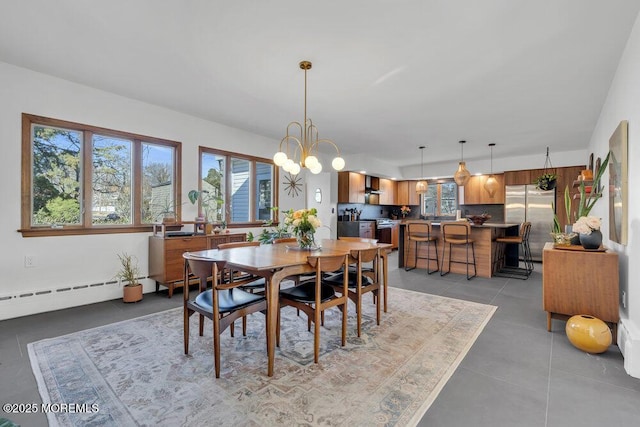 dining room featuring light tile patterned flooring, a chandelier, and a baseboard radiator