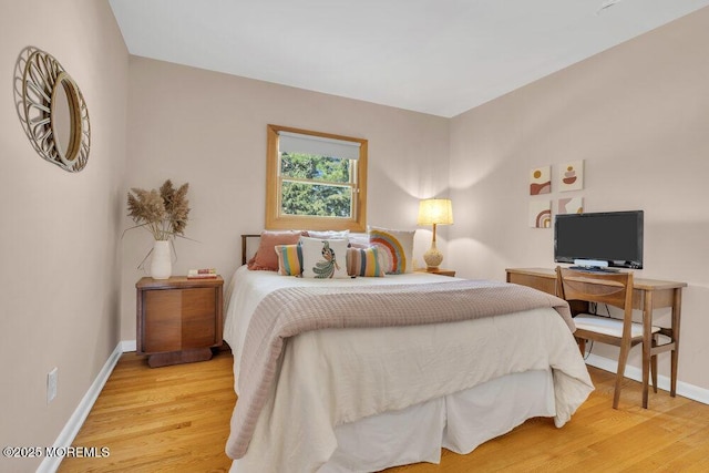 bedroom with baseboards and wood finished floors