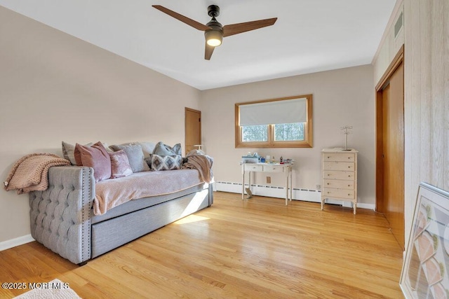 bedroom featuring light wood-type flooring, baseboards, visible vents, and ceiling fan