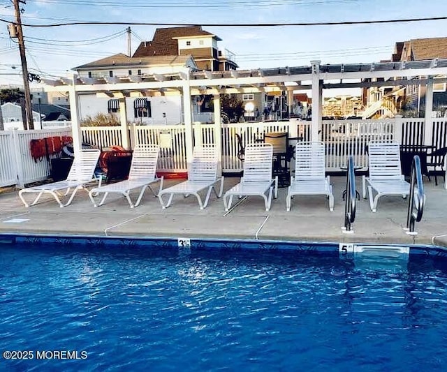 pool featuring a patio area and fence