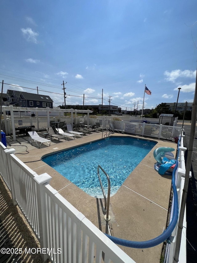 pool featuring a patio and a fenced backyard