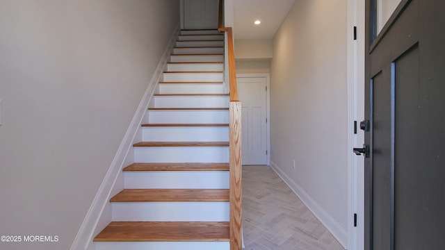 staircase featuring baseboards and recessed lighting