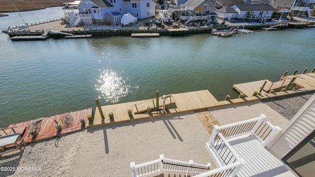 dock area with a water view and a residential view