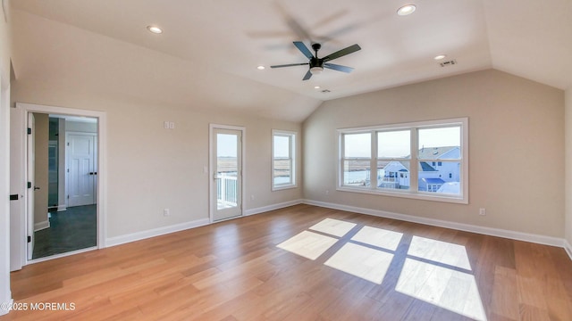 spare room featuring recessed lighting, visible vents, vaulted ceiling, light wood-type flooring, and baseboards