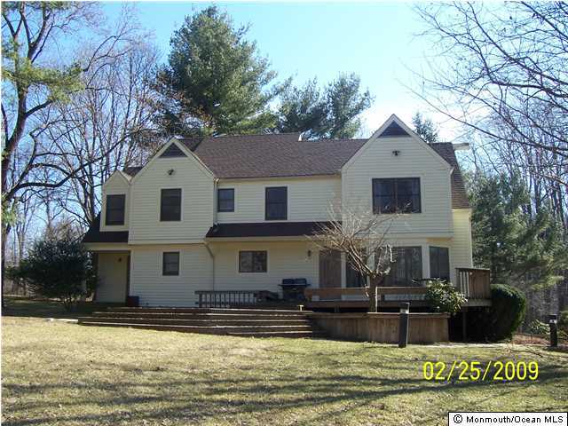 back of house with a yard and a deck