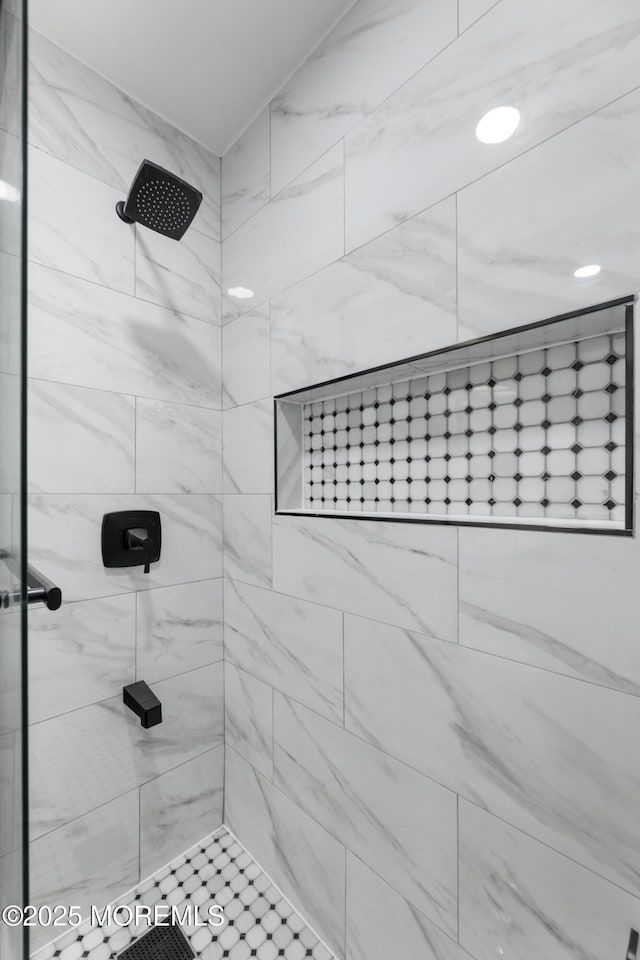 bathroom with tiled shower