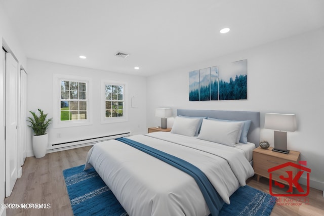 bedroom featuring baseboard heating, recessed lighting, light wood-style floors, and visible vents