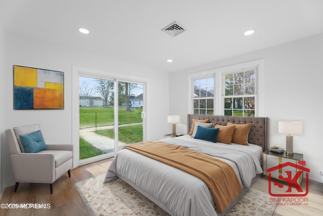 bedroom featuring recessed lighting, visible vents, wood finished floors, and access to outside