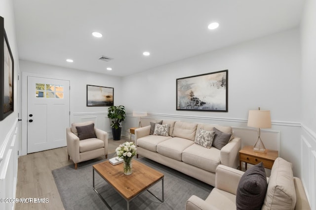 living room with visible vents, recessed lighting, and light wood-type flooring