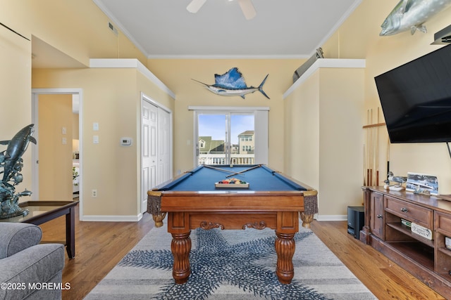 recreation room with visible vents, crown molding, baseboards, and wood finished floors