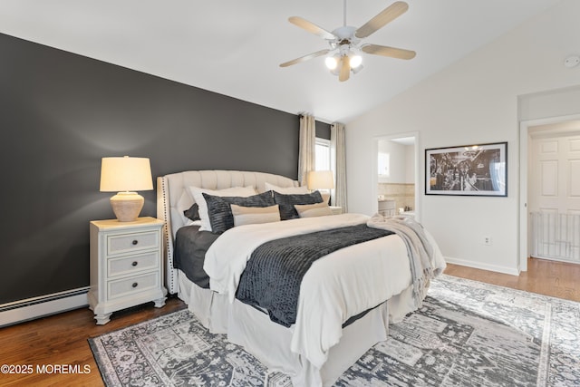 bedroom featuring baseboard heating, ensuite bathroom, vaulted ceiling, wood finished floors, and baseboards