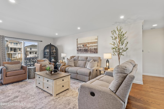 living room featuring baseboards, light wood finished floors, and recessed lighting