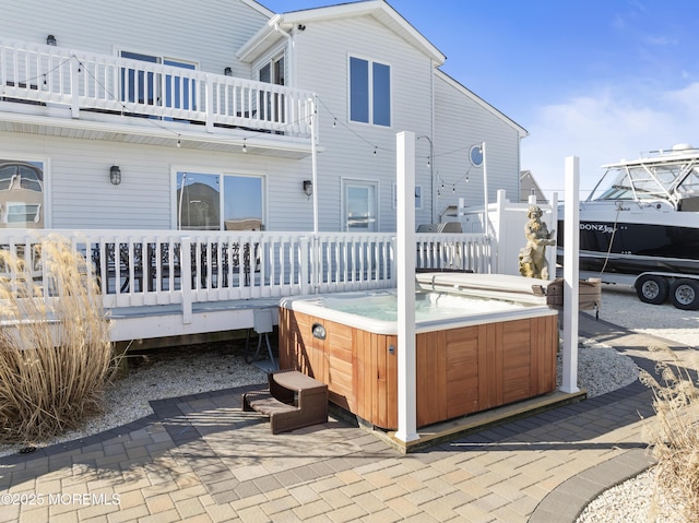 exterior space with a deck and a hot tub