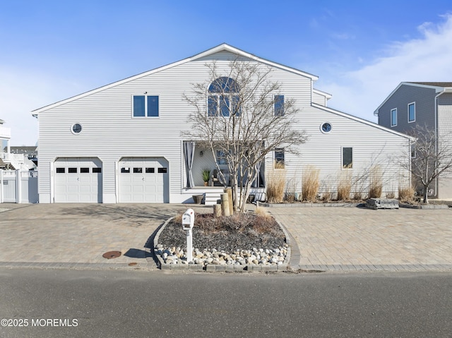 view of front of property with an attached garage and decorative driveway