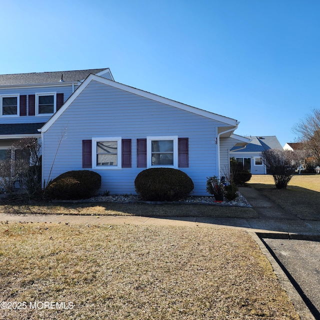 view of property exterior with a lawn