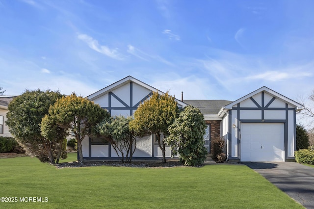 tudor-style house featuring stucco siding, driveway, an attached garage, and a front yard