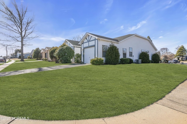 view of front facade with a front lawn, roof with shingles, concrete driveway, a garage, and central AC unit