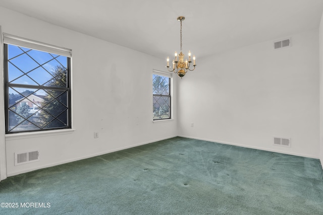 carpeted spare room featuring a notable chandelier, visible vents, and baseboards