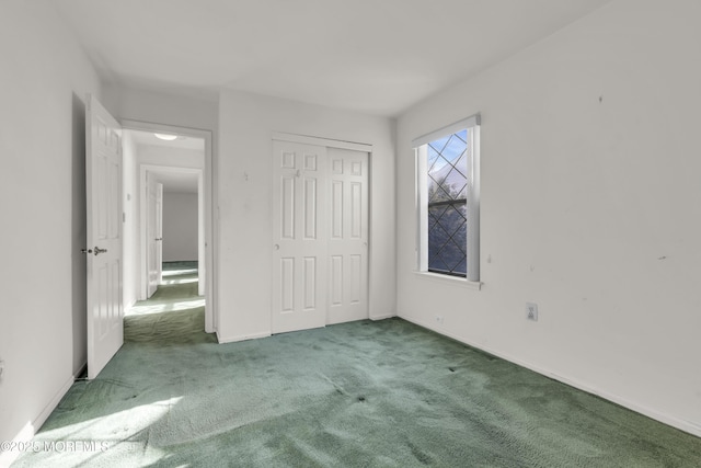 unfurnished bedroom with a closet, baseboards, and carpet floors