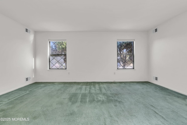 carpeted empty room with visible vents