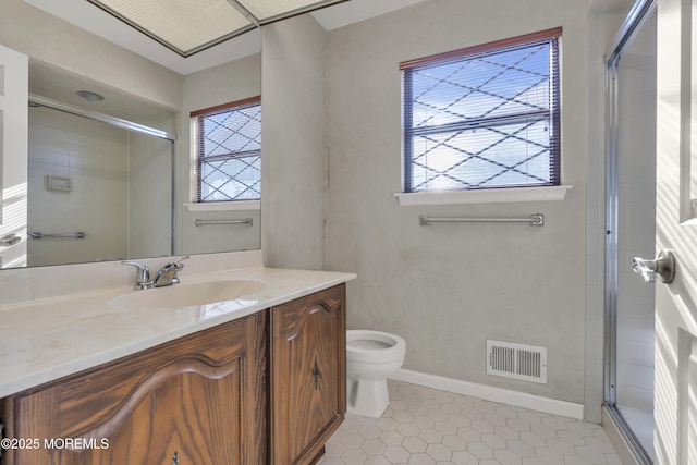 full bathroom featuring visible vents, toilet, a stall shower, baseboards, and vanity