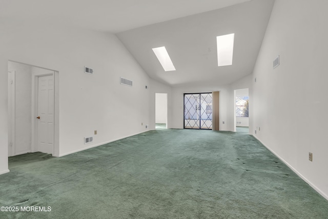 unfurnished room featuring visible vents, carpet floors, and a skylight