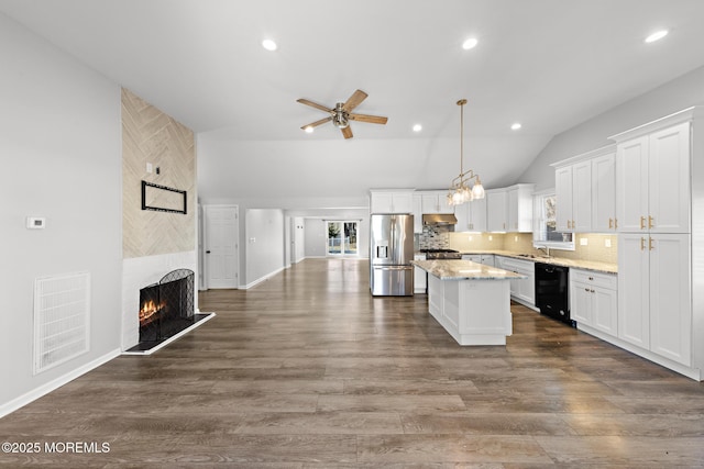 kitchen with stainless steel fridge, visible vents, wine cooler, a center island, and under cabinet range hood