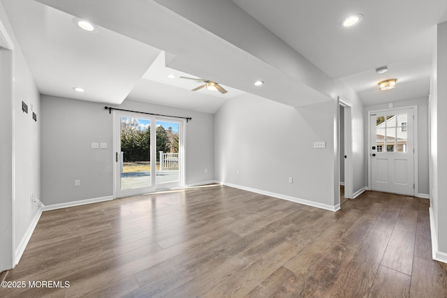 unfurnished living room featuring baseboards, wood finished floors, a ceiling fan, and recessed lighting