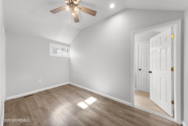 bonus room with lofted ceiling, visible vents, baseboards, and wood finished floors