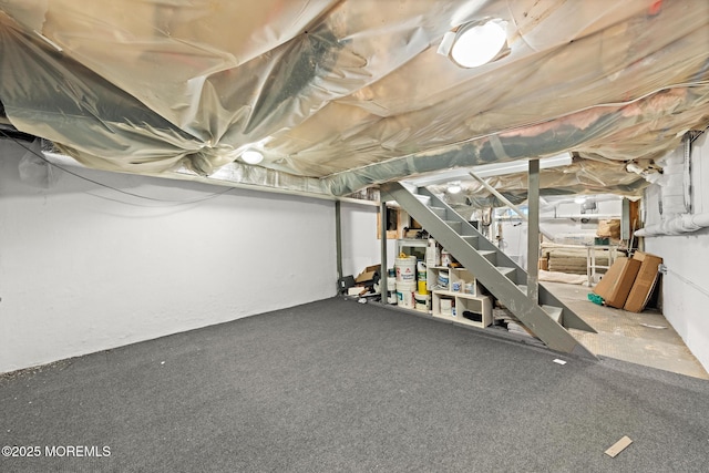 unfinished basement featuring stairway