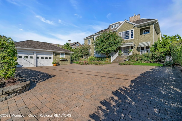 view of front facade with decorative driveway and an attached garage