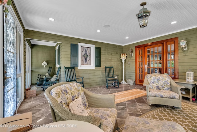 living room with recessed lighting and wood walls