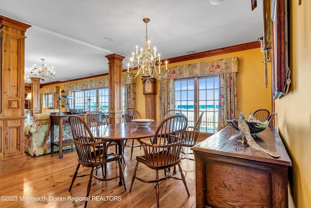 dining room featuring a chandelier, plenty of natural light, decorative columns, and ornamental molding