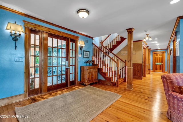 doorway to outside featuring ornamental molding, stairway, and hardwood / wood-style flooring