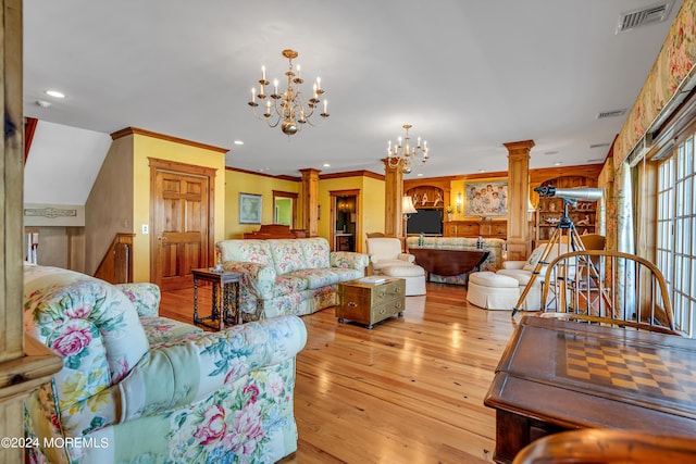 living area featuring visible vents, a chandelier, decorative columns, and light wood-style floors