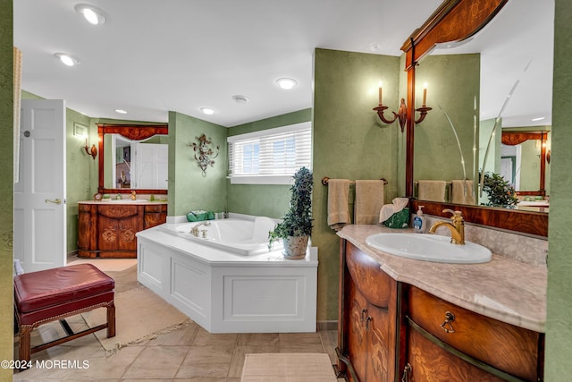 full bath with two vanities, a garden tub, and a sink