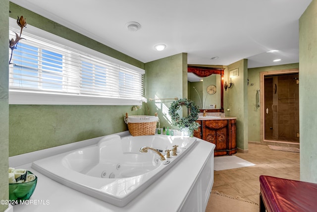 full bathroom featuring a jetted tub, a shower stall, and vanity