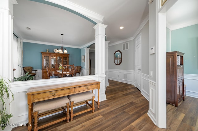 dining area featuring dark wood finished floors, visible vents, and decorative columns