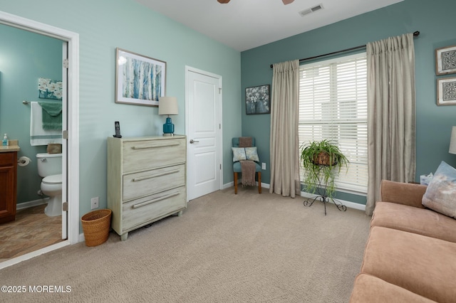 sitting room featuring light carpet, ceiling fan, visible vents, and baseboards