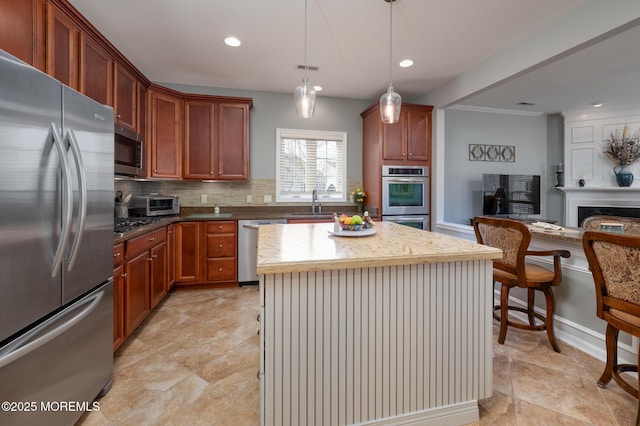 kitchen with appliances with stainless steel finishes, recessed lighting, a sink, and decorative backsplash