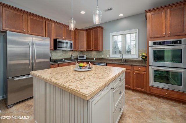 kitchen featuring recessed lighting, visible vents, decorative backsplash, appliances with stainless steel finishes, and a sink