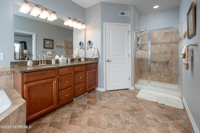 full bath featuring a garden tub, double vanity, visible vents, a stall shower, and a sink