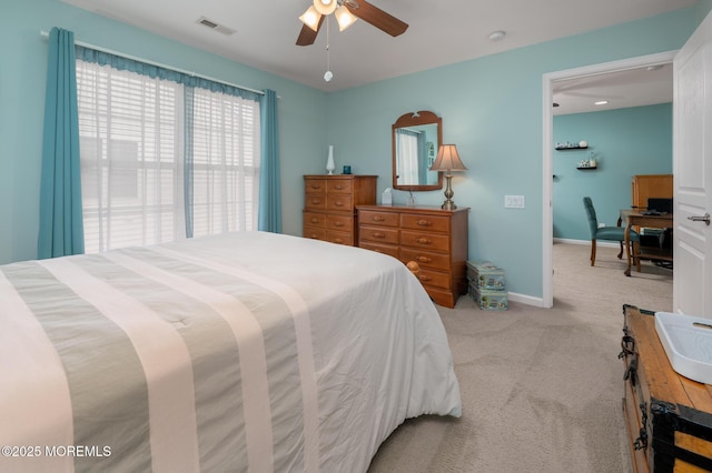 bedroom featuring a ceiling fan, visible vents, light carpet, and baseboards