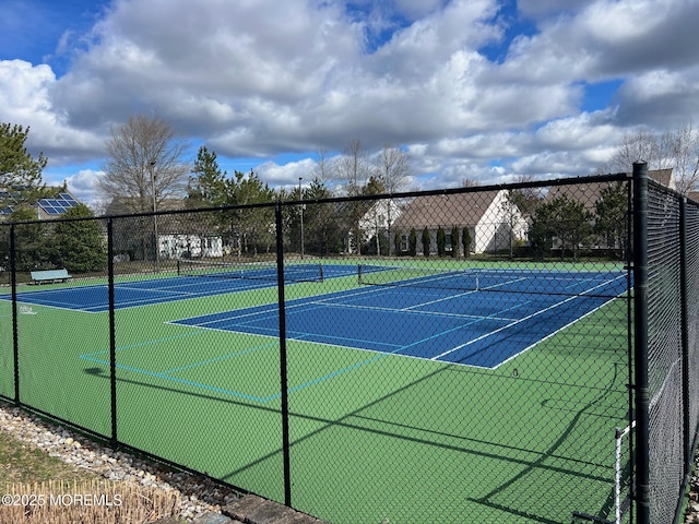 view of tennis court with fence