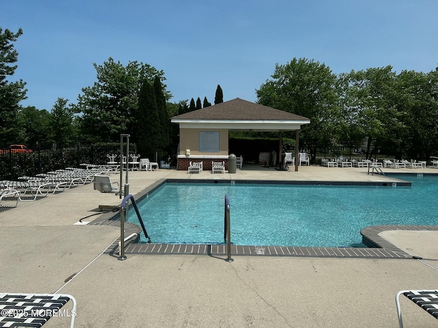 pool featuring a patio area and fence