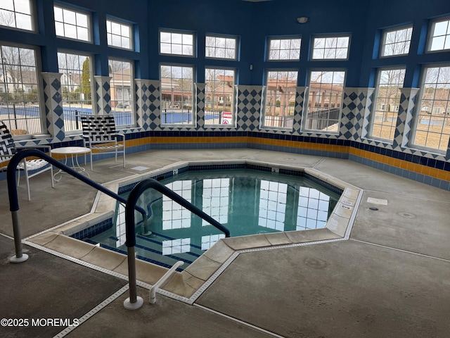 view of pool with an indoor hot tub