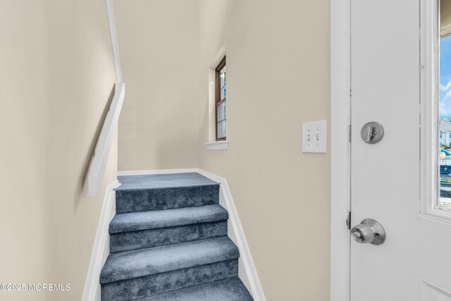 staircase featuring baseboards