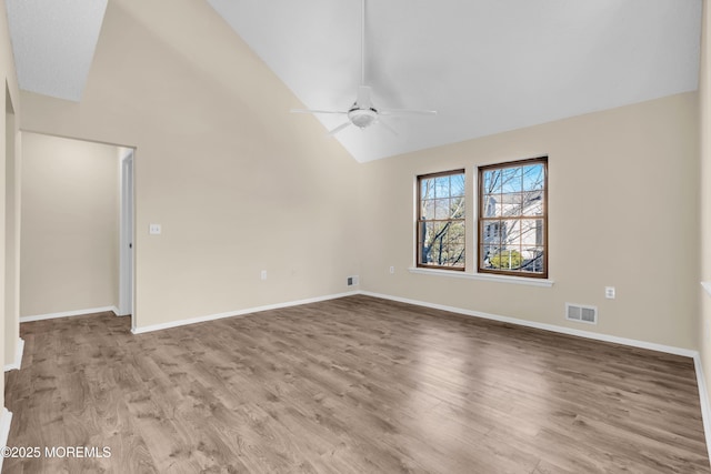 unfurnished room featuring high vaulted ceiling, wood finished floors, visible vents, baseboards, and a ceiling fan