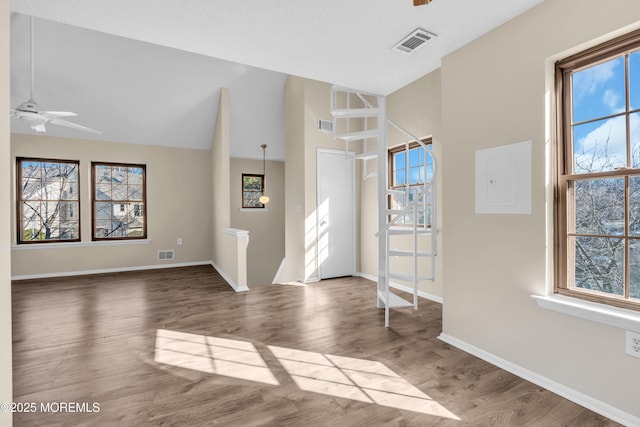 entryway featuring ceiling fan, a wealth of natural light, wood finished floors, and visible vents